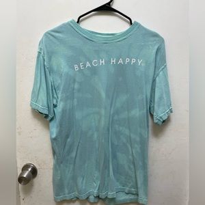 lightly worn teal shirt with lettering